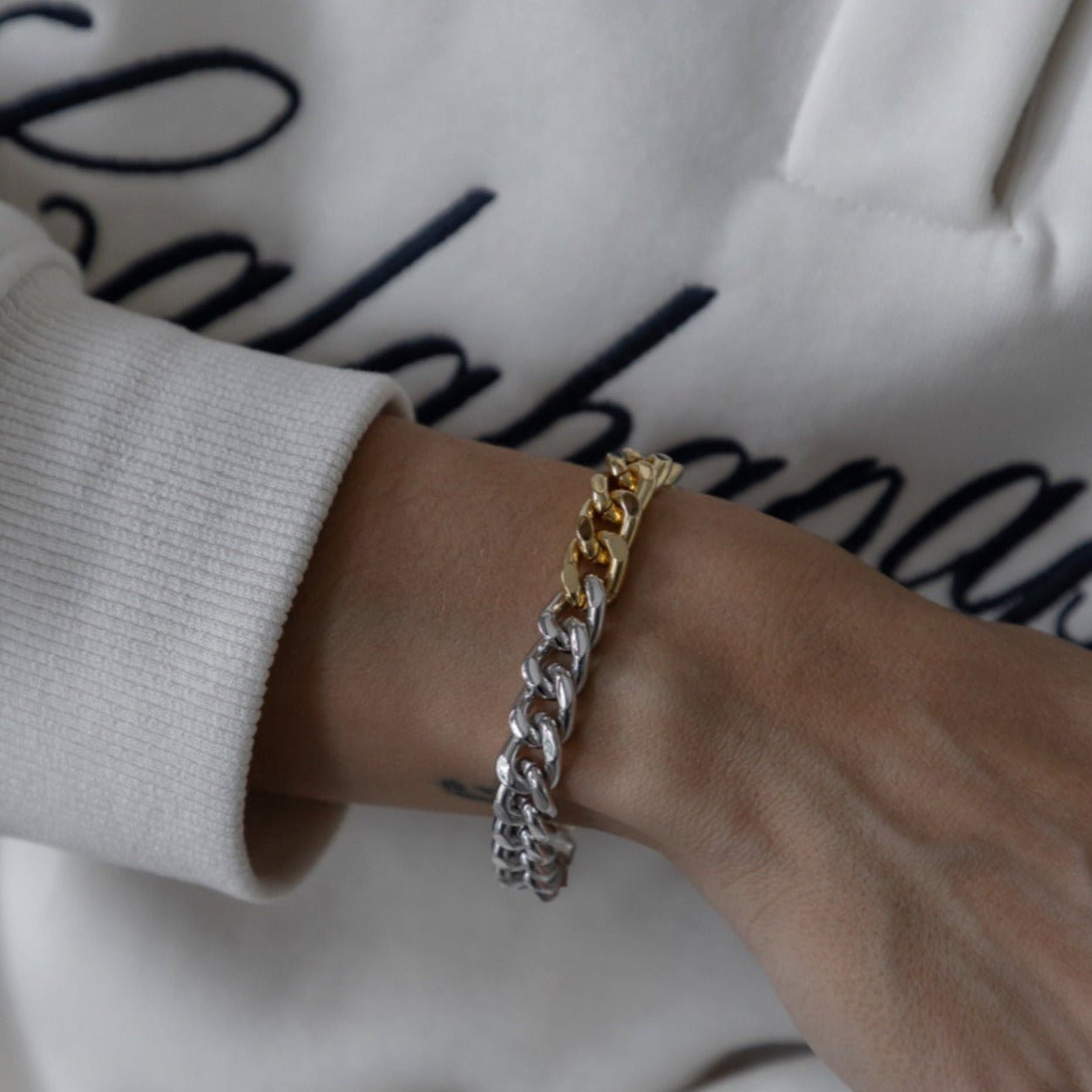 Paulina bracelet with mixed gold and silver chain links, worn on wrist - Luiza Jewelry