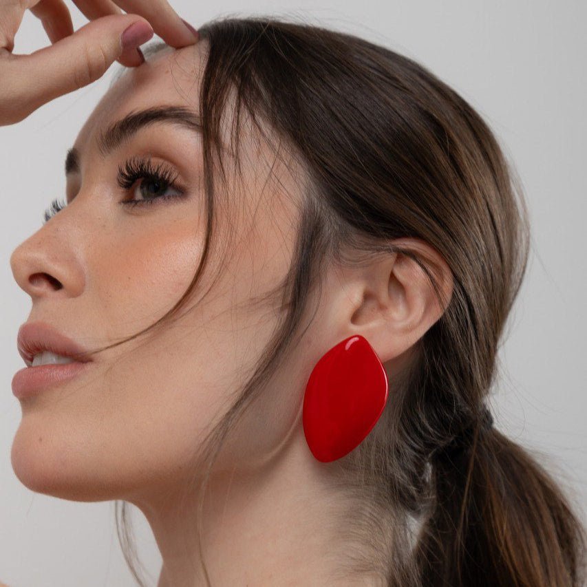 Model wearing Avery earring in red resin – 6.5 cm statement design