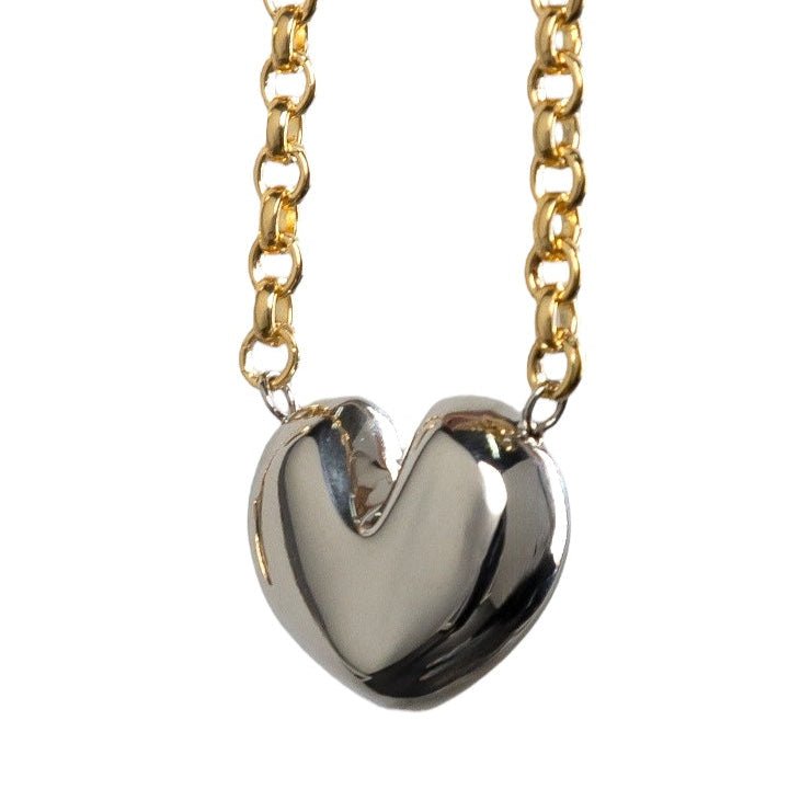 Alicia necklace – gold chain with a large silver heart pendant, close-up view
- Luiza Jewelry