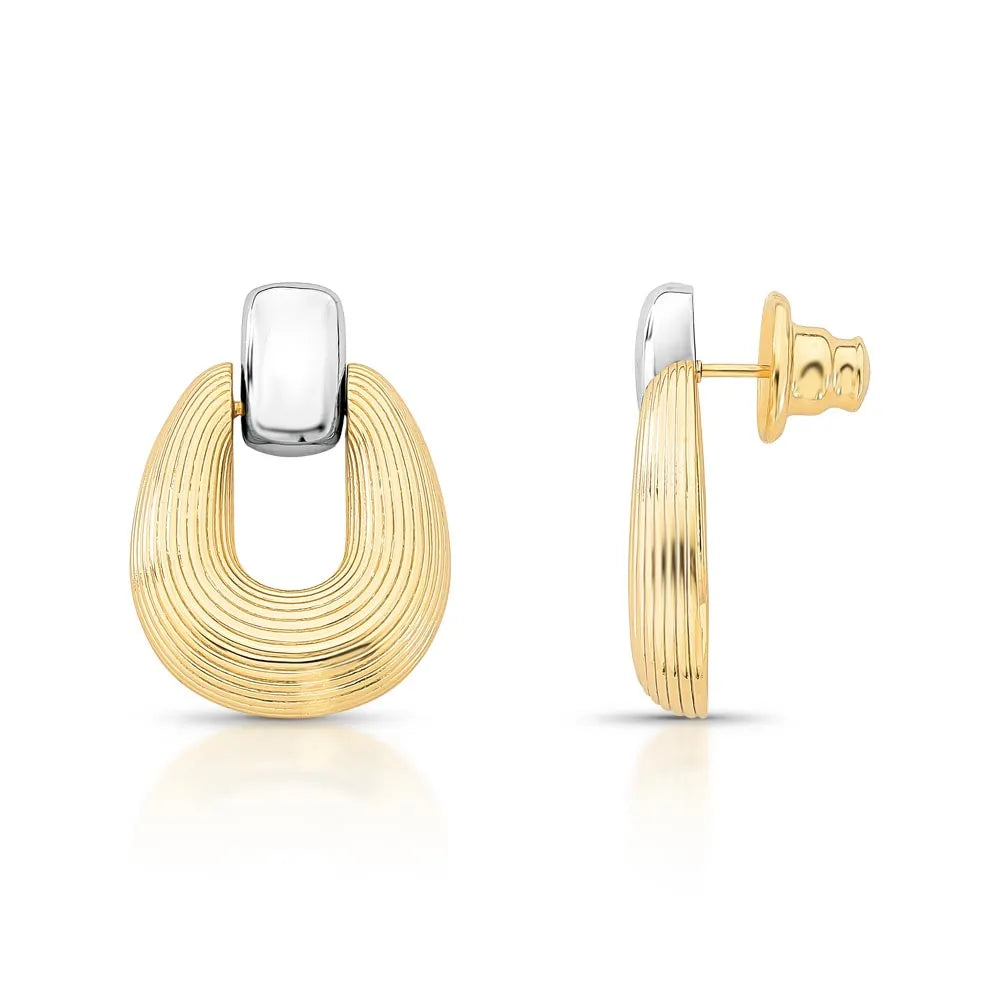 Nicole Earrings – gold and silver sculptural drop. Close-up of 18k gold and rhodium earrings – Nicole