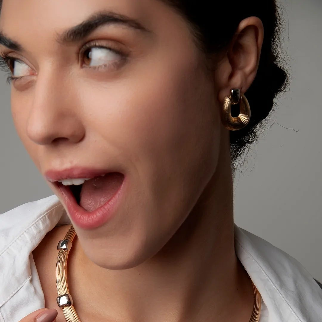 Model wearing duo-tone earrings – Nicole by Luiza Jewelry